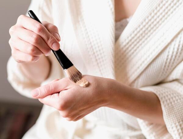 close up foundation applied hand