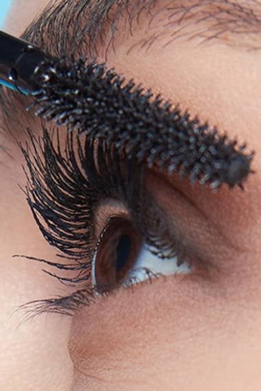 Close up of a woman applying mascara on her Eyelashes